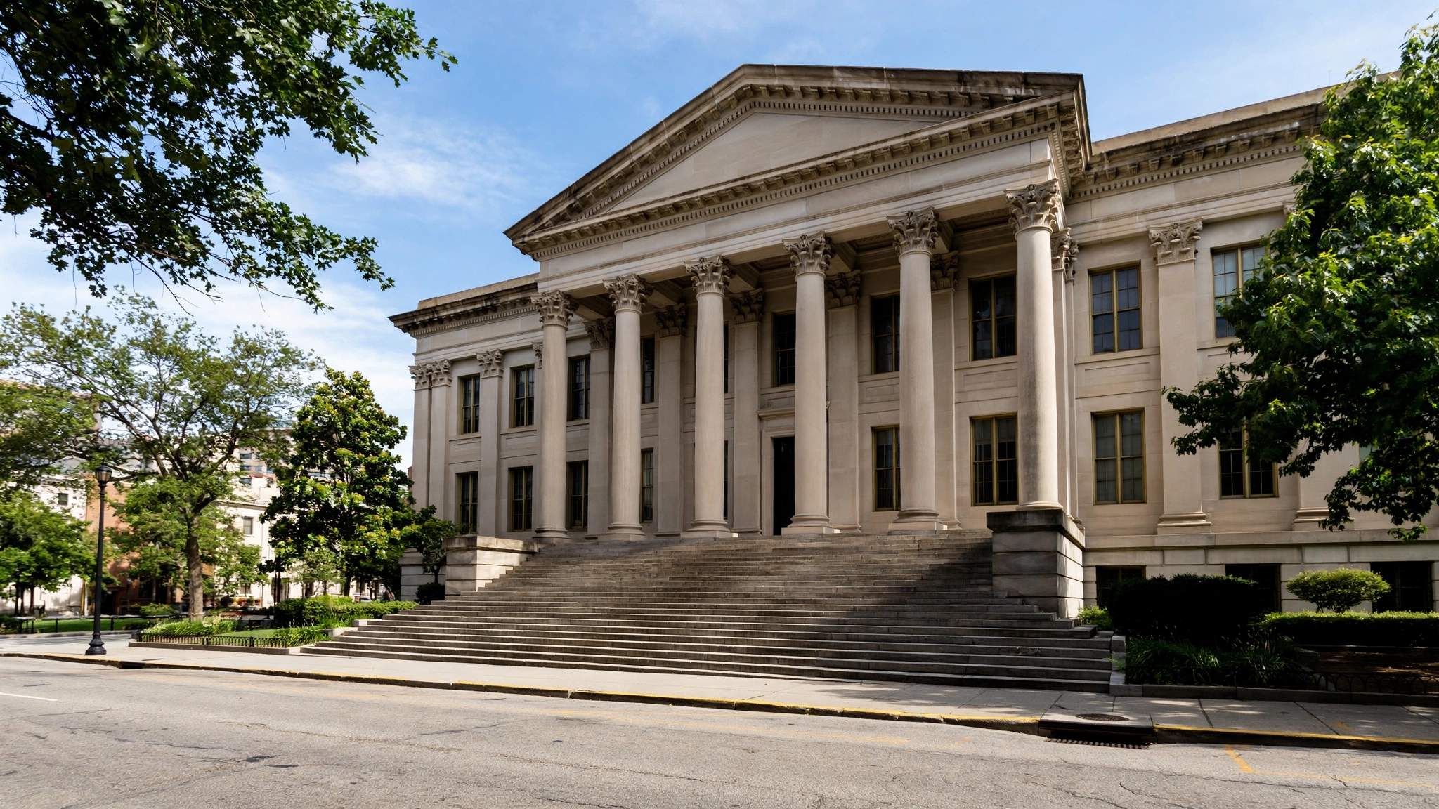 A neoclassical courthouse building with tall stone columns and wide front steps