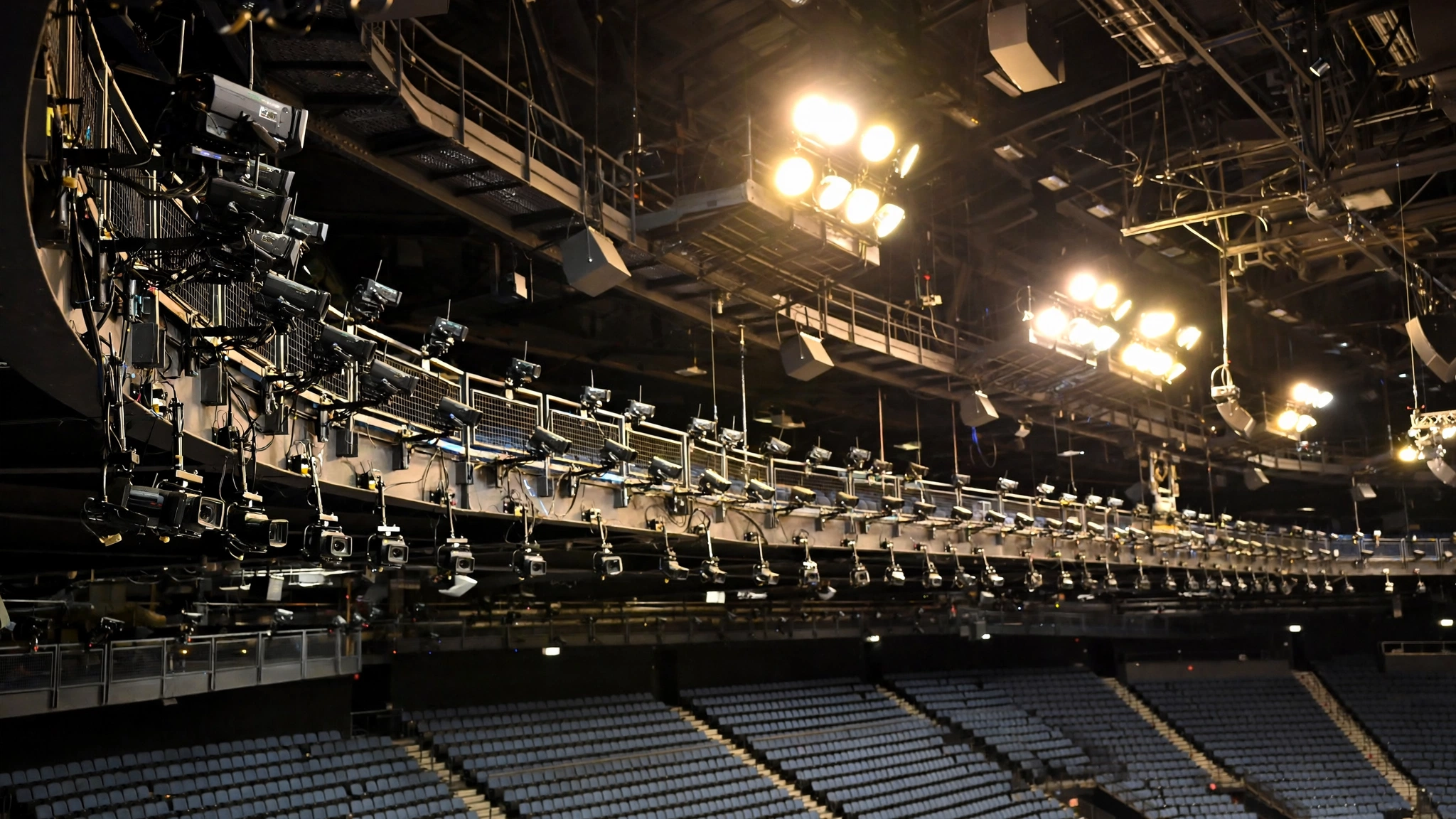 Rows of broadcast cameras mounted around the upper level of an indoor sports arena