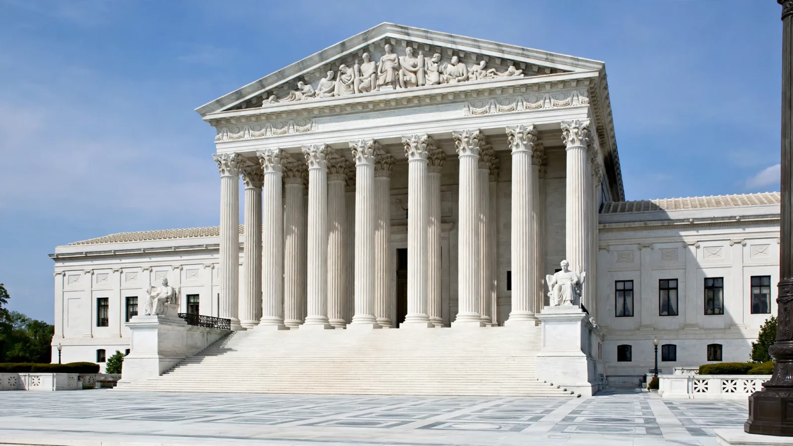 The white marble facade and tall columns of the United States Supreme Court building in Washington