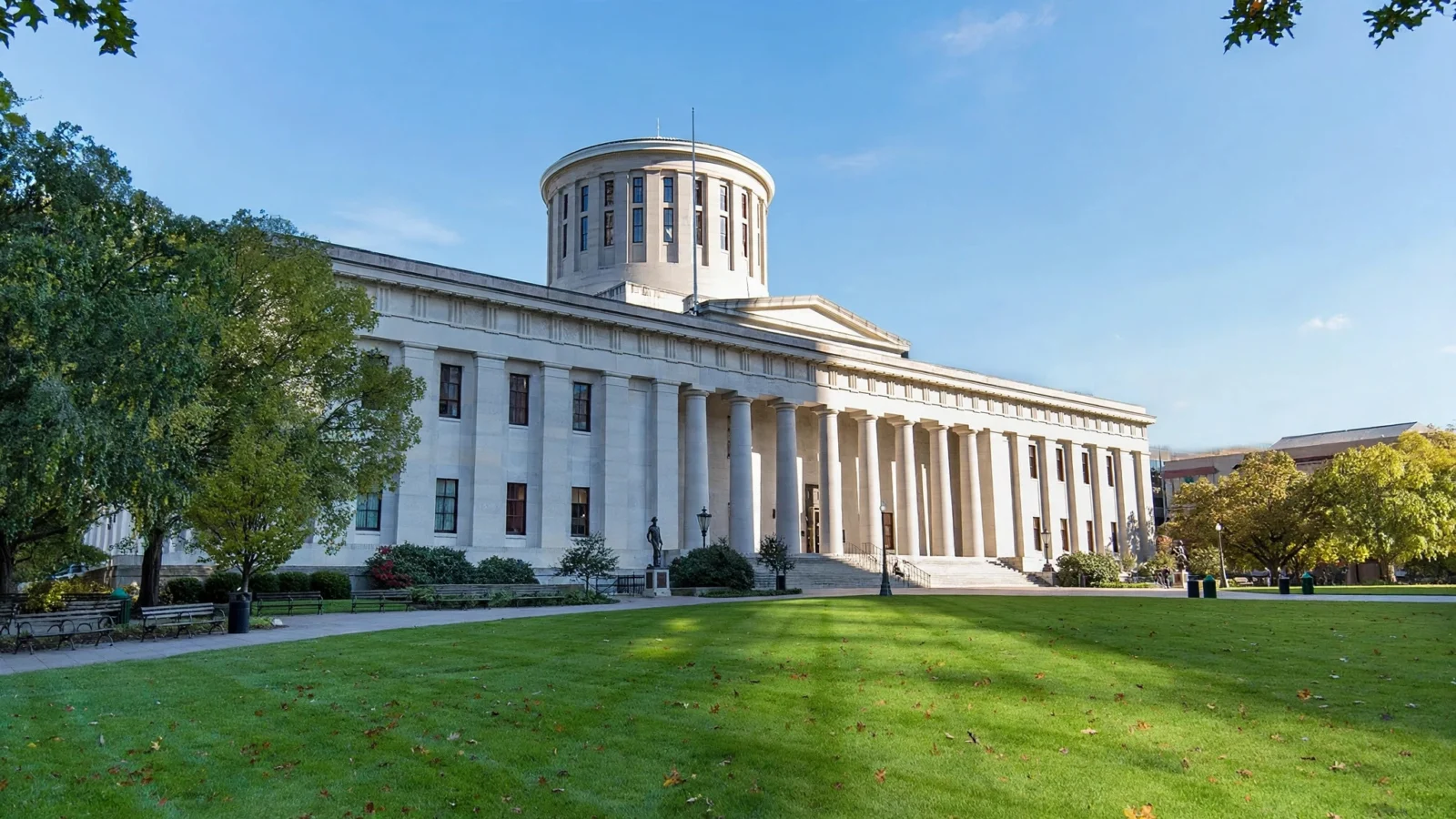 The Ohio Statehouse in Columbus, a limestone government building with a domed cupola, on a clear day