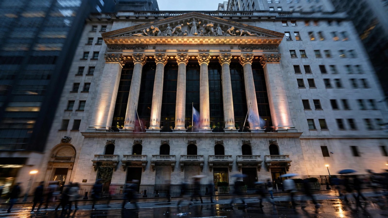 The New York Stock Exchange facade at dusk with blurred pedestrians passing in front.