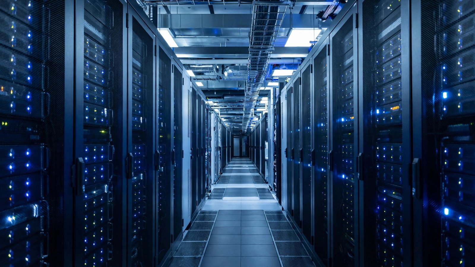 A long aisle of server racks with blinking indicator lights in a modern data center