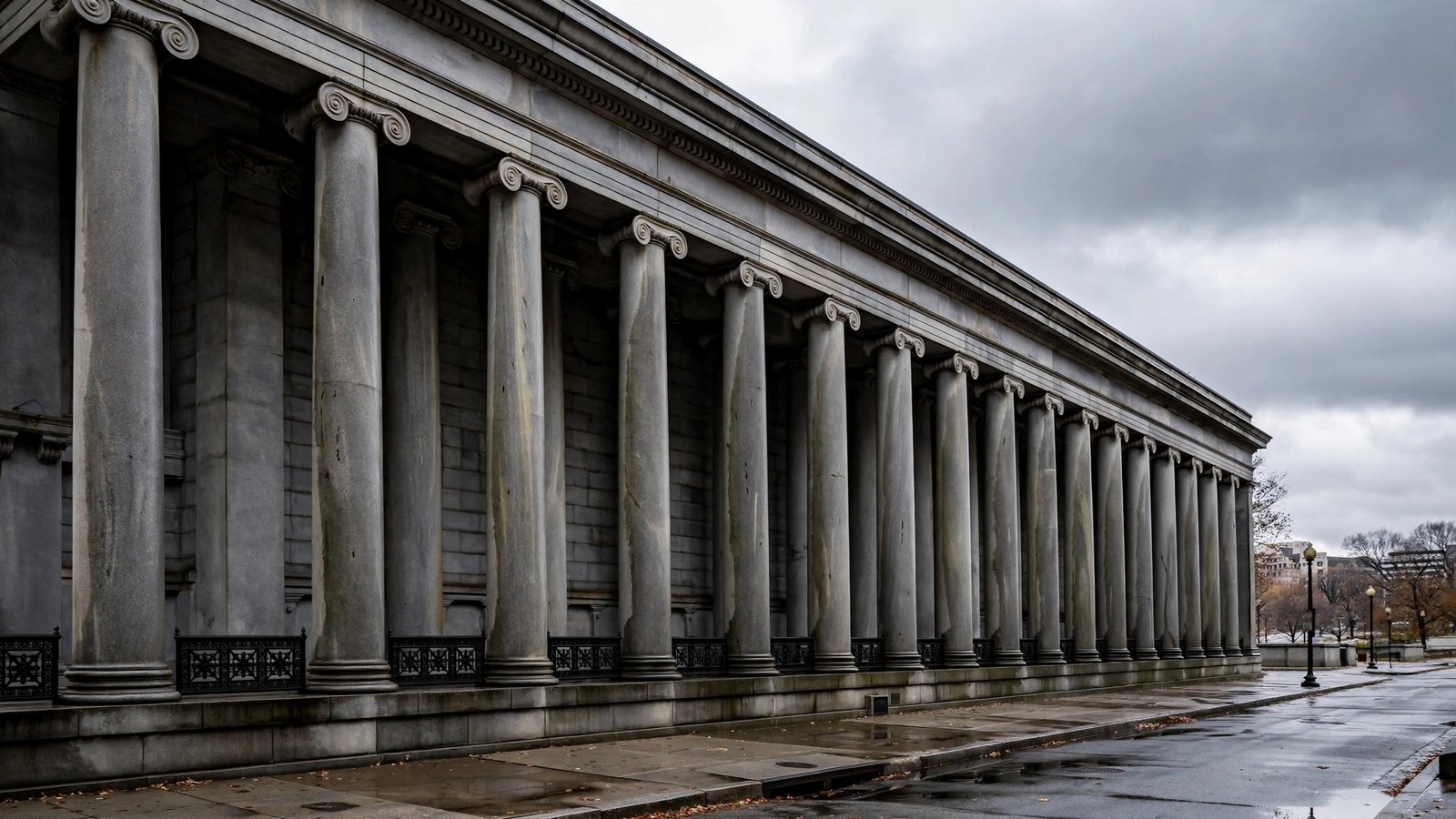 Stone columns of the US Treasury Department building under an overcast sky in Washington DC