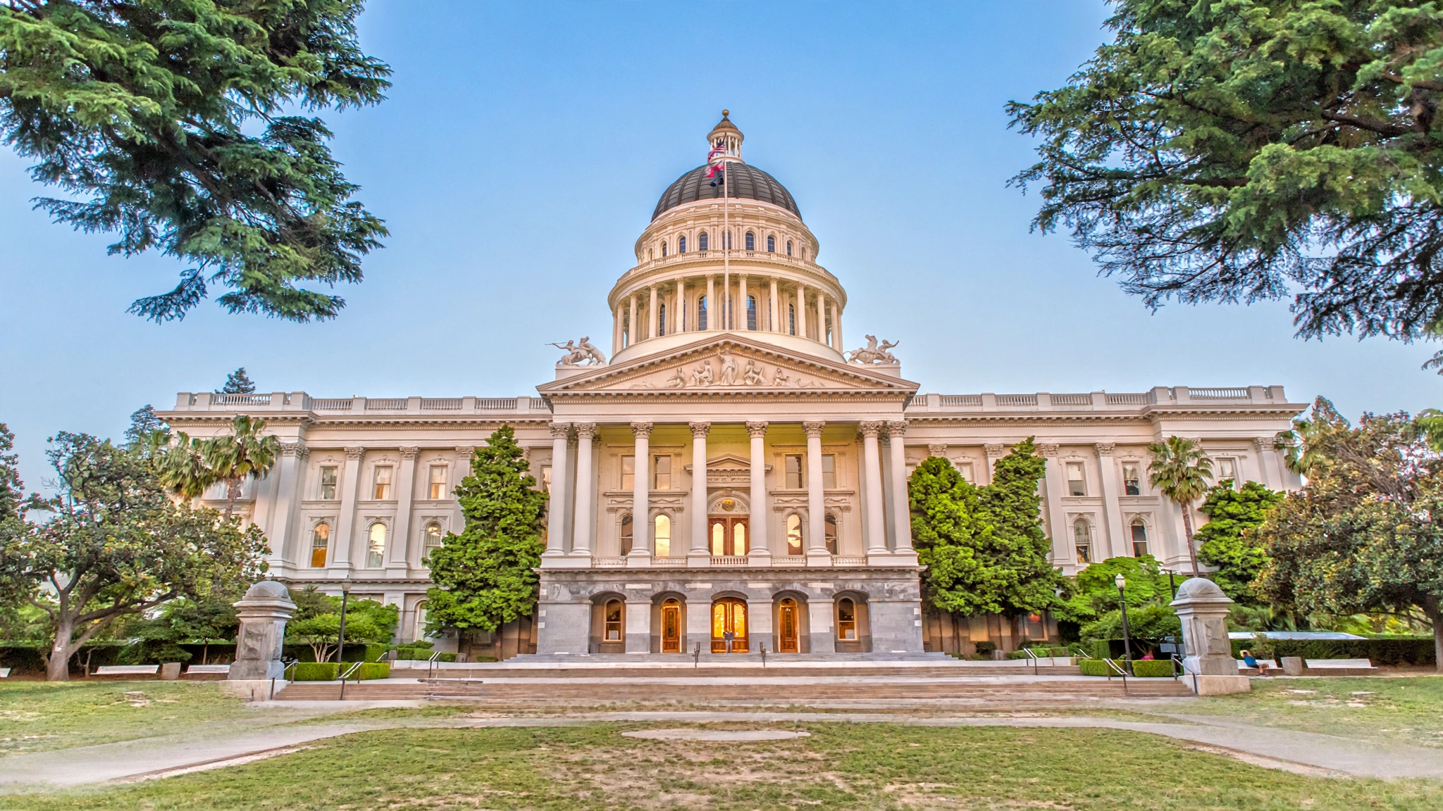 The California state capitol building in Sacramento under a clear blue sky, an editorial illustration.