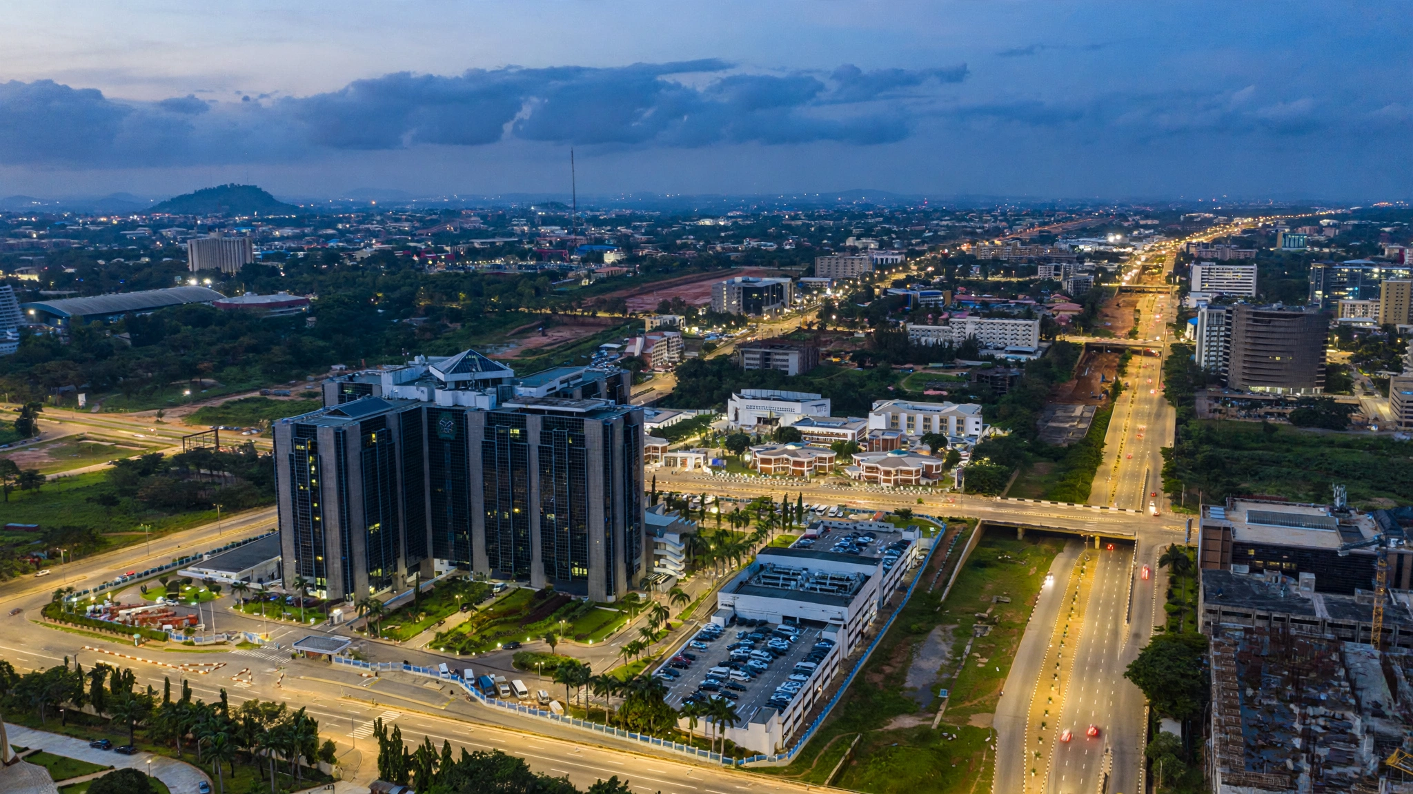 Aerial view of Abuja, Nigeria at dusk with government buildings and wide roads