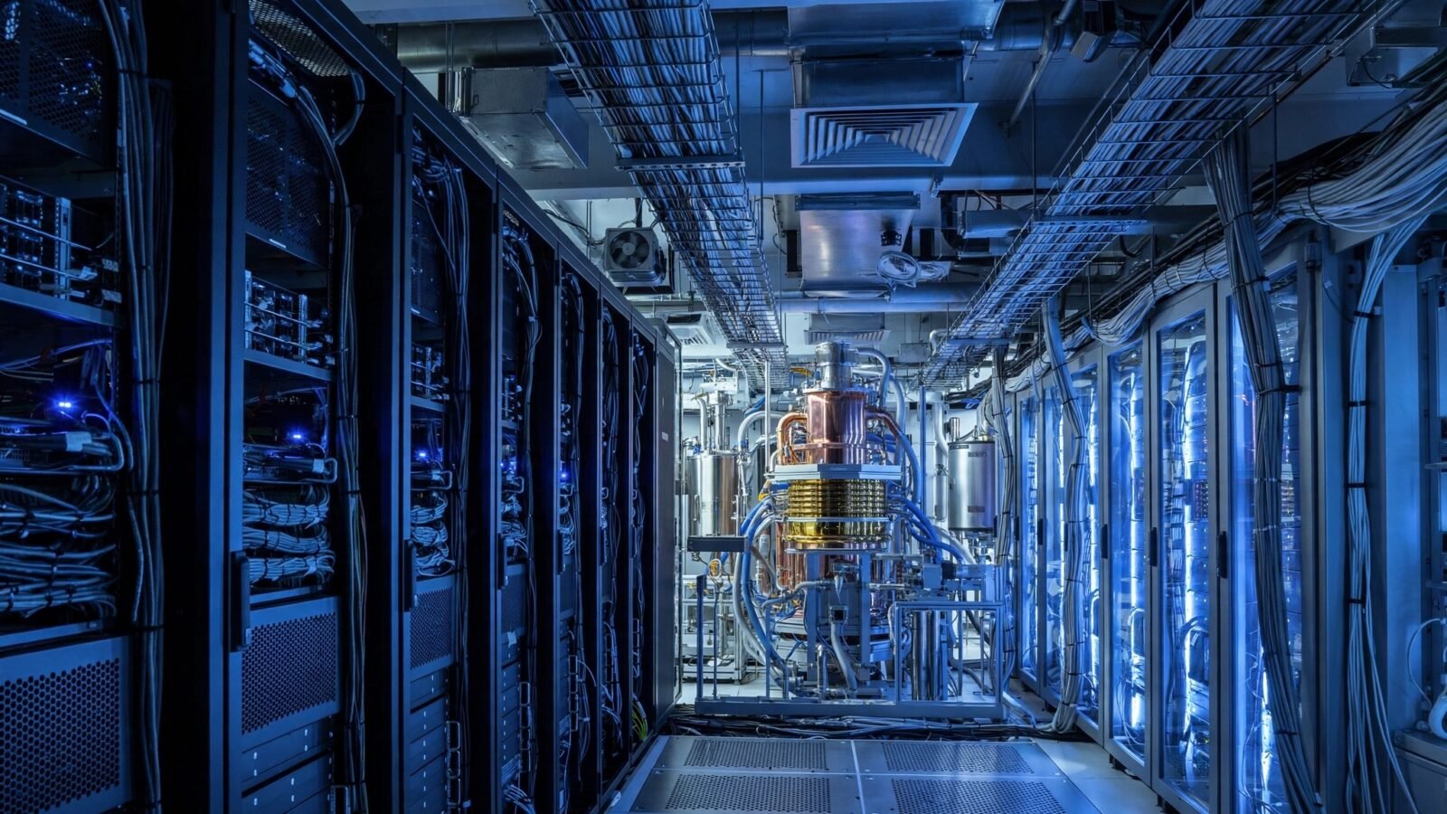 A blue-lit data center corridor with rows of server racks and quantum-computing equipment, illustrating cybersecurity and quantum computing infrastructure.