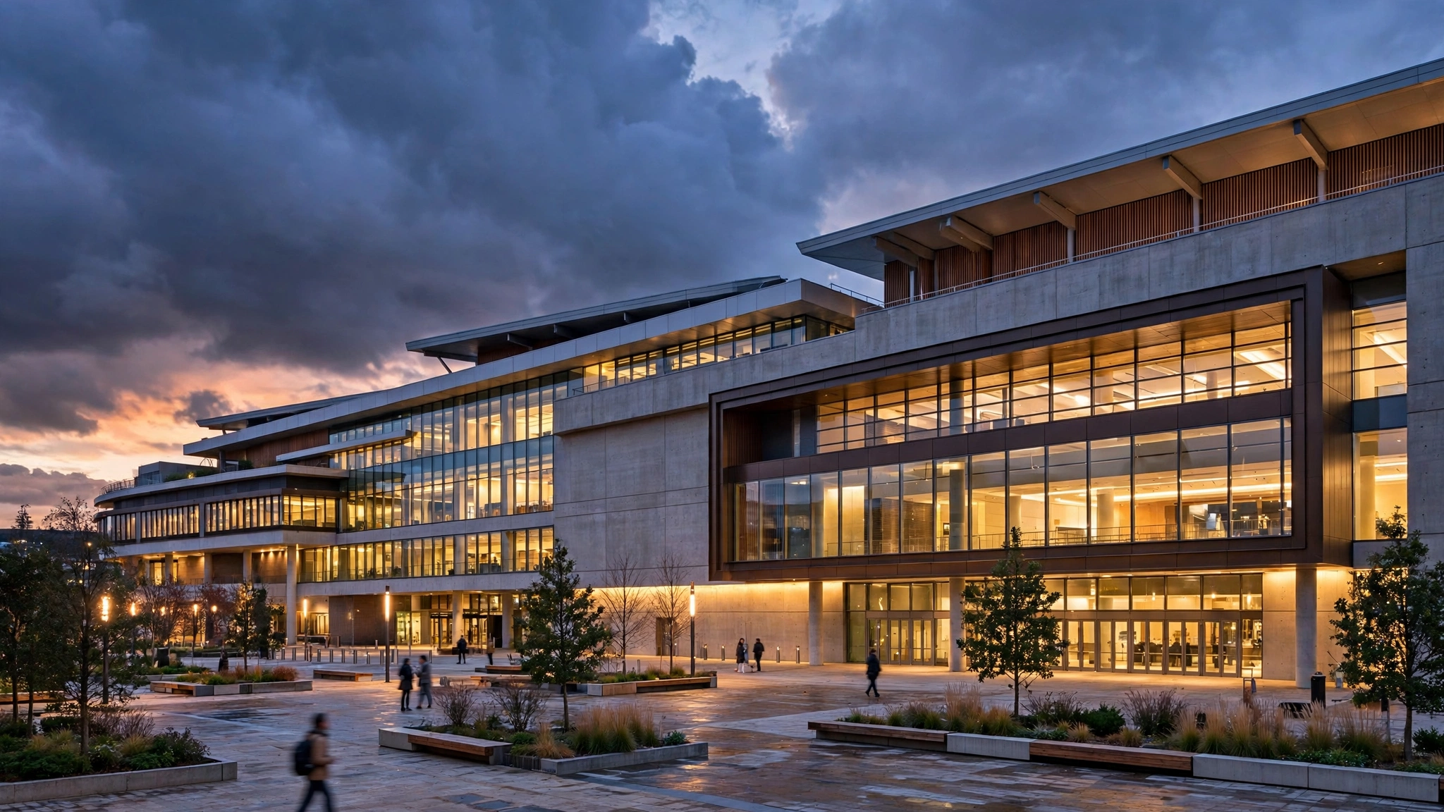 Modern convention center exterior at dusk with a lit plaza
