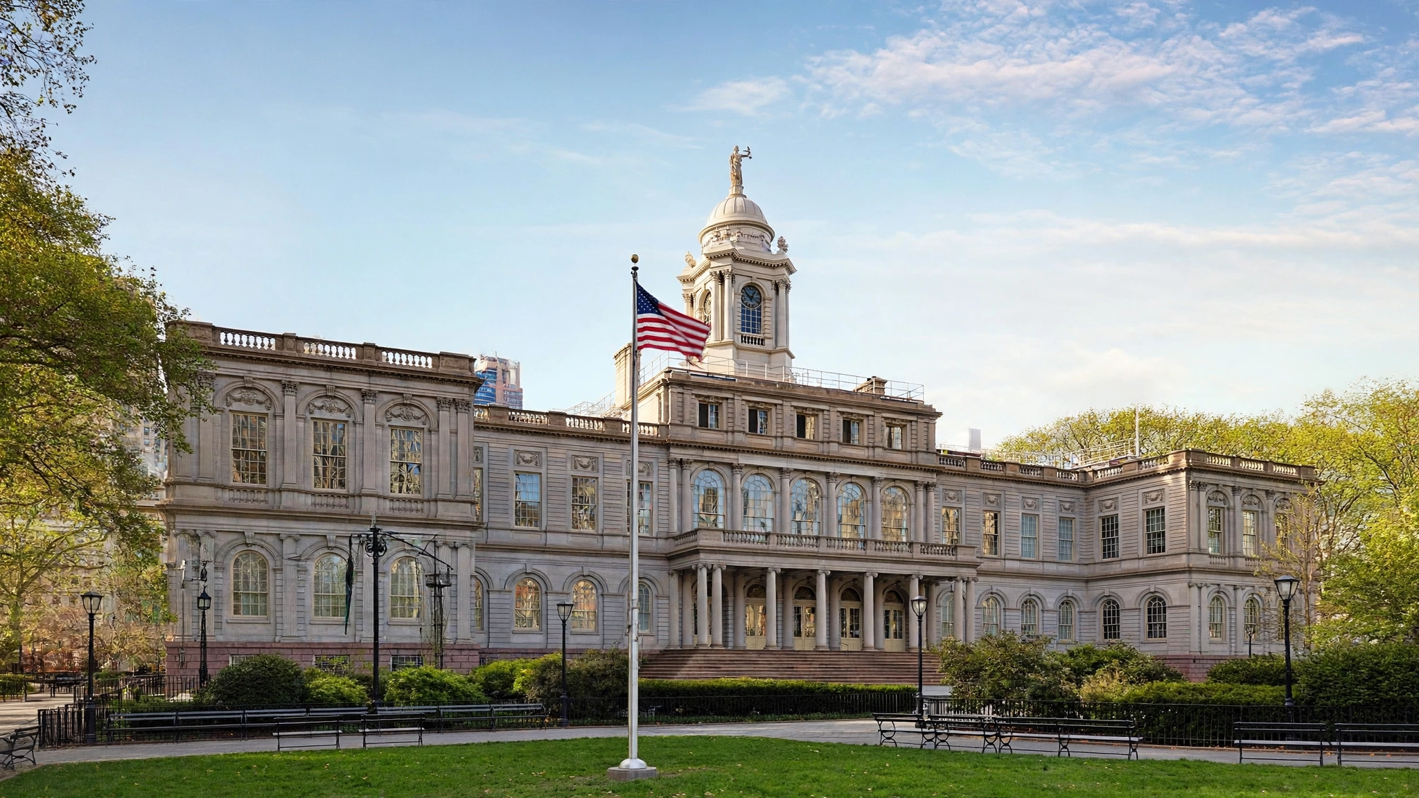 New York City Hall, a historic building with a clock-tower cupola, on a sunny day