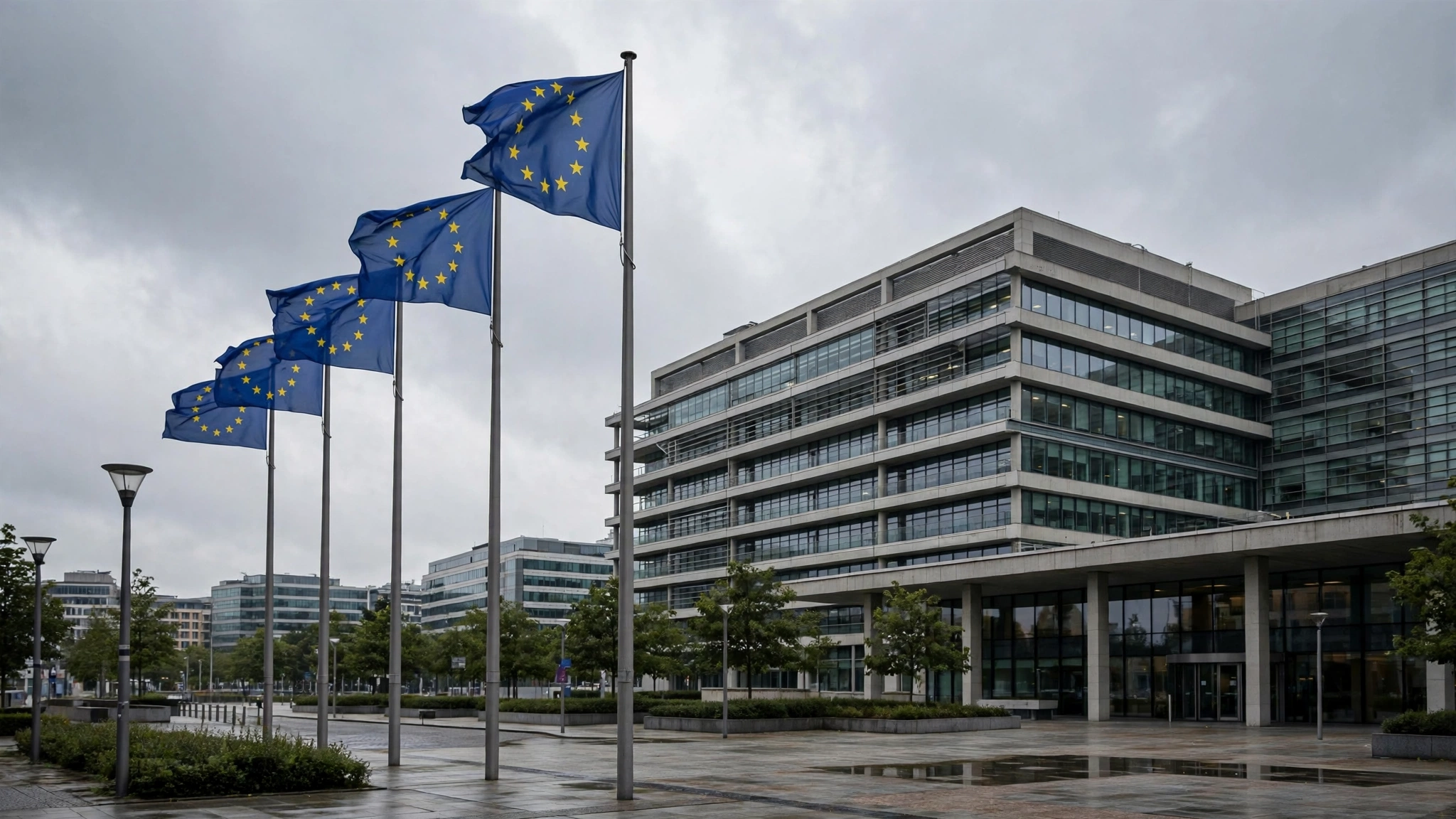 European Union flags on poles in front of a modern office building
