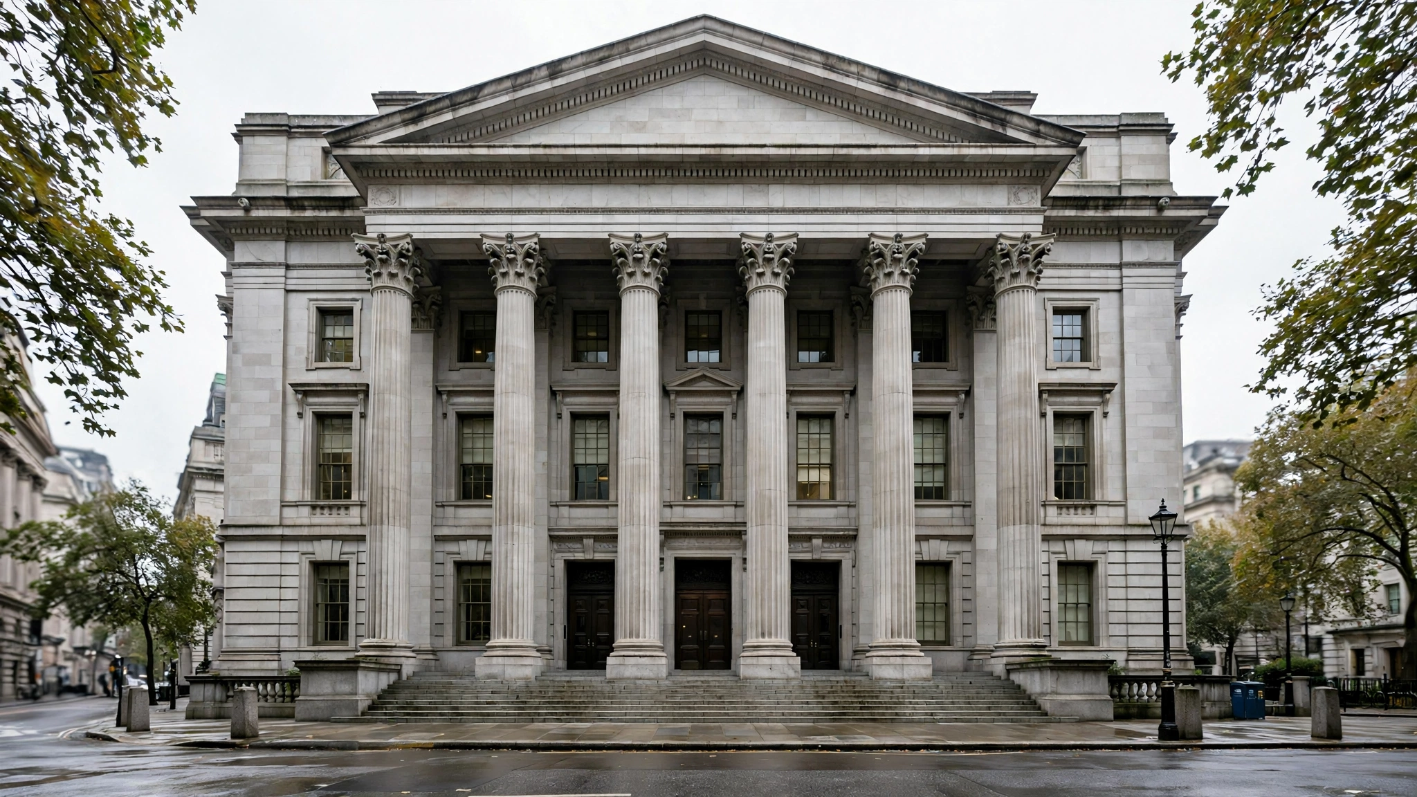A stone central bank building with tall columns viewed from the street.