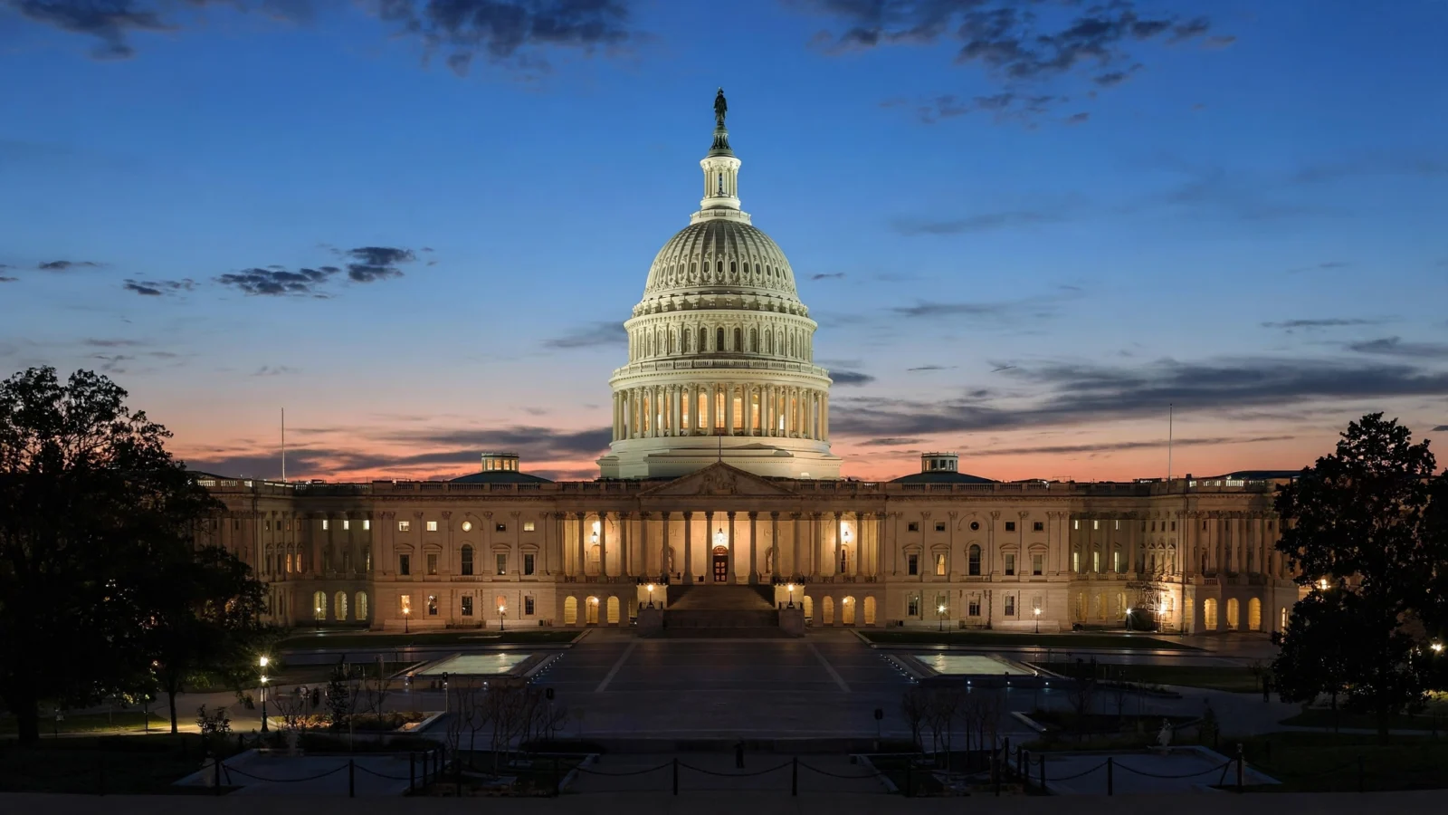 The United States Capitol building dome at dusk in Washington, D.C.