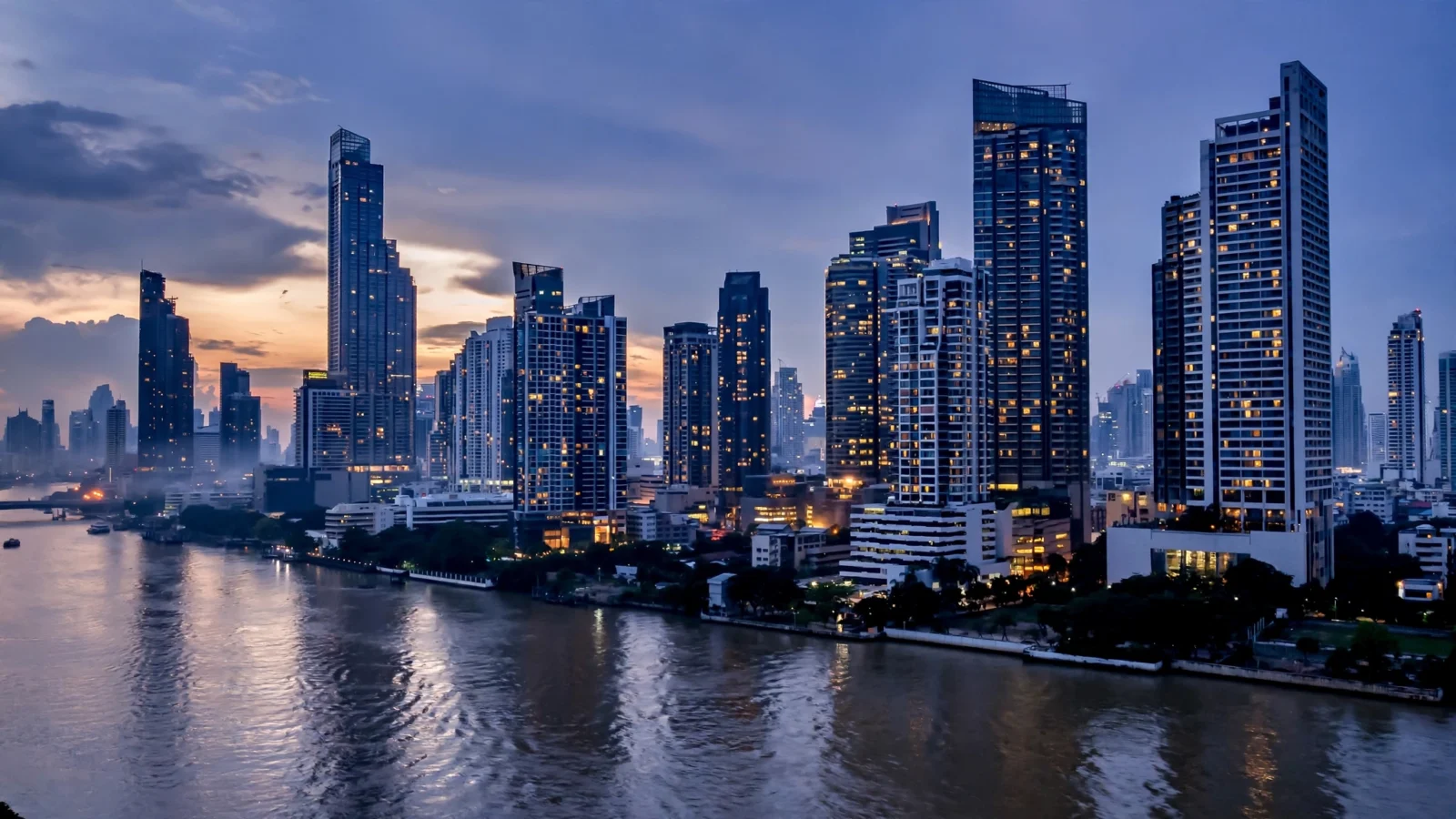 The financial district skyline of Bangkok, Thailand, at dusk.