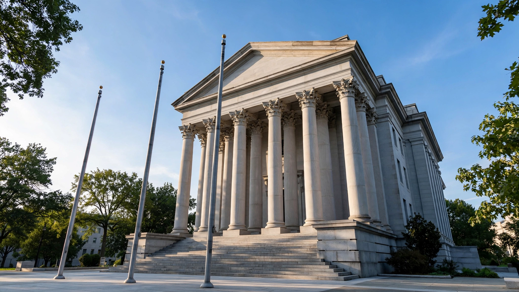 A neoclassical federal building with tall stone columns under a clear blue sky.