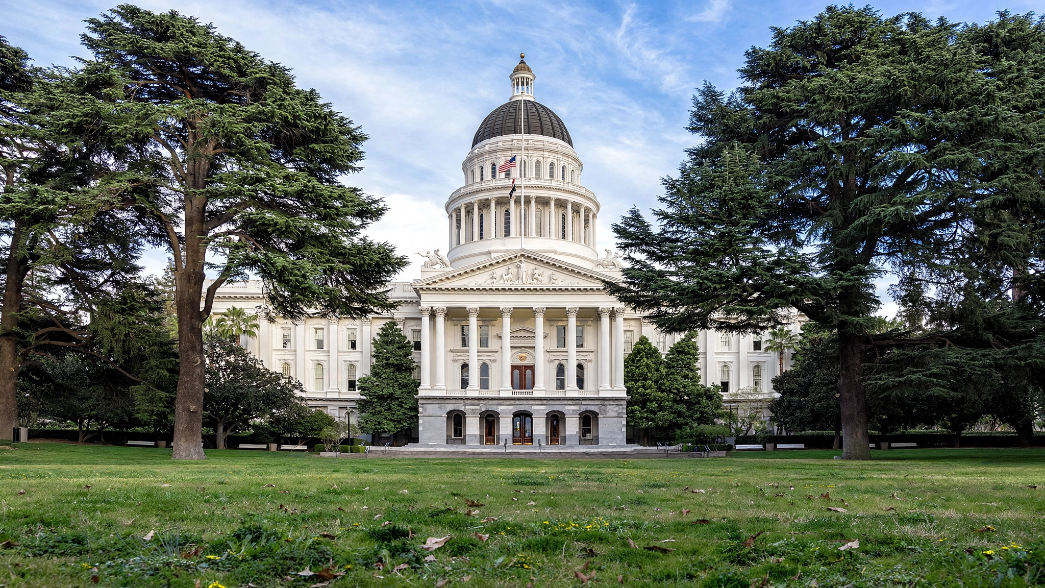 The California State Capitol building in Sacramento with its dome, seen across the lawn