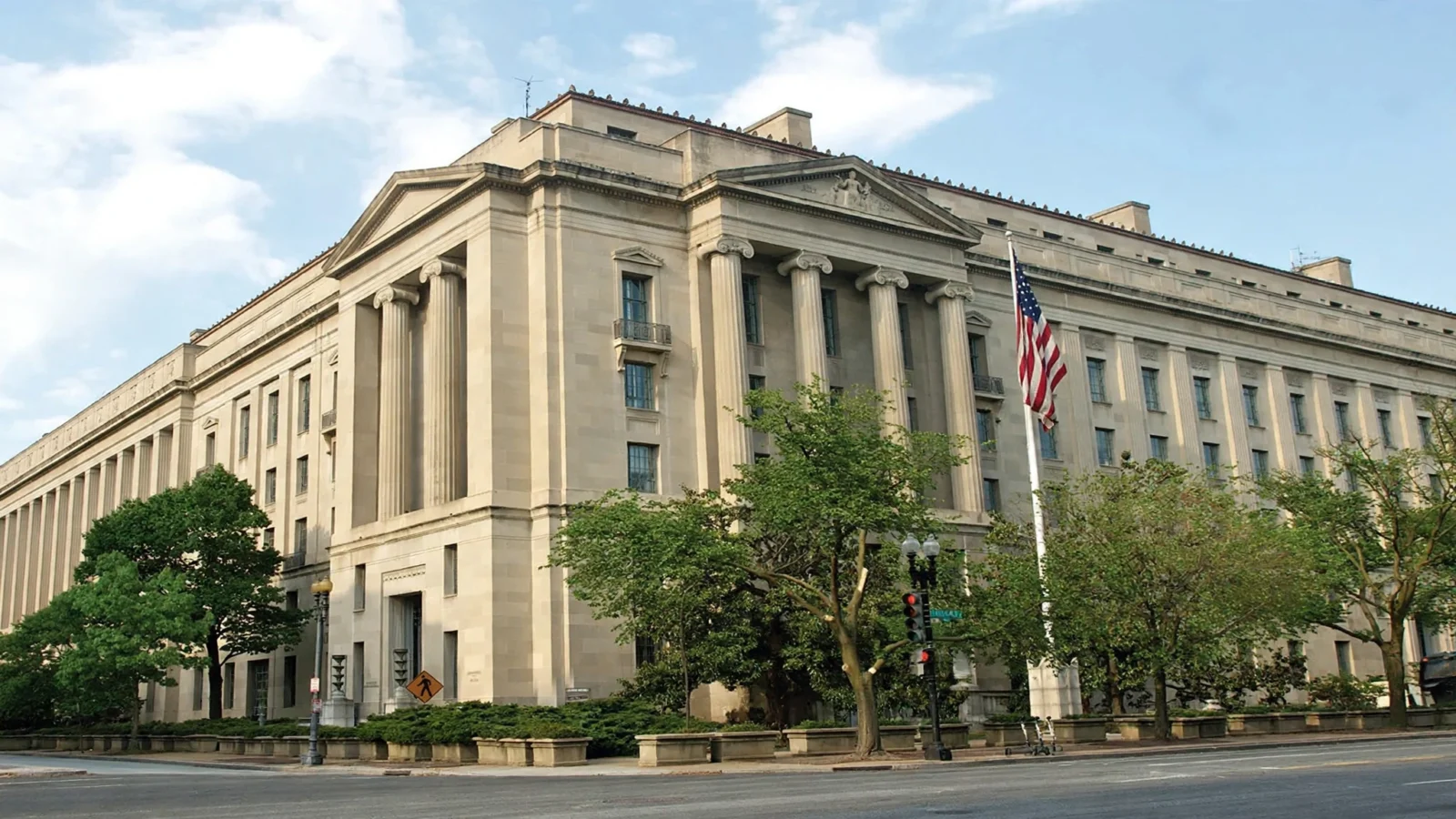 The Robert F. Kennedy Department of Justice building in Washington, D.C., with an American flag flying outside