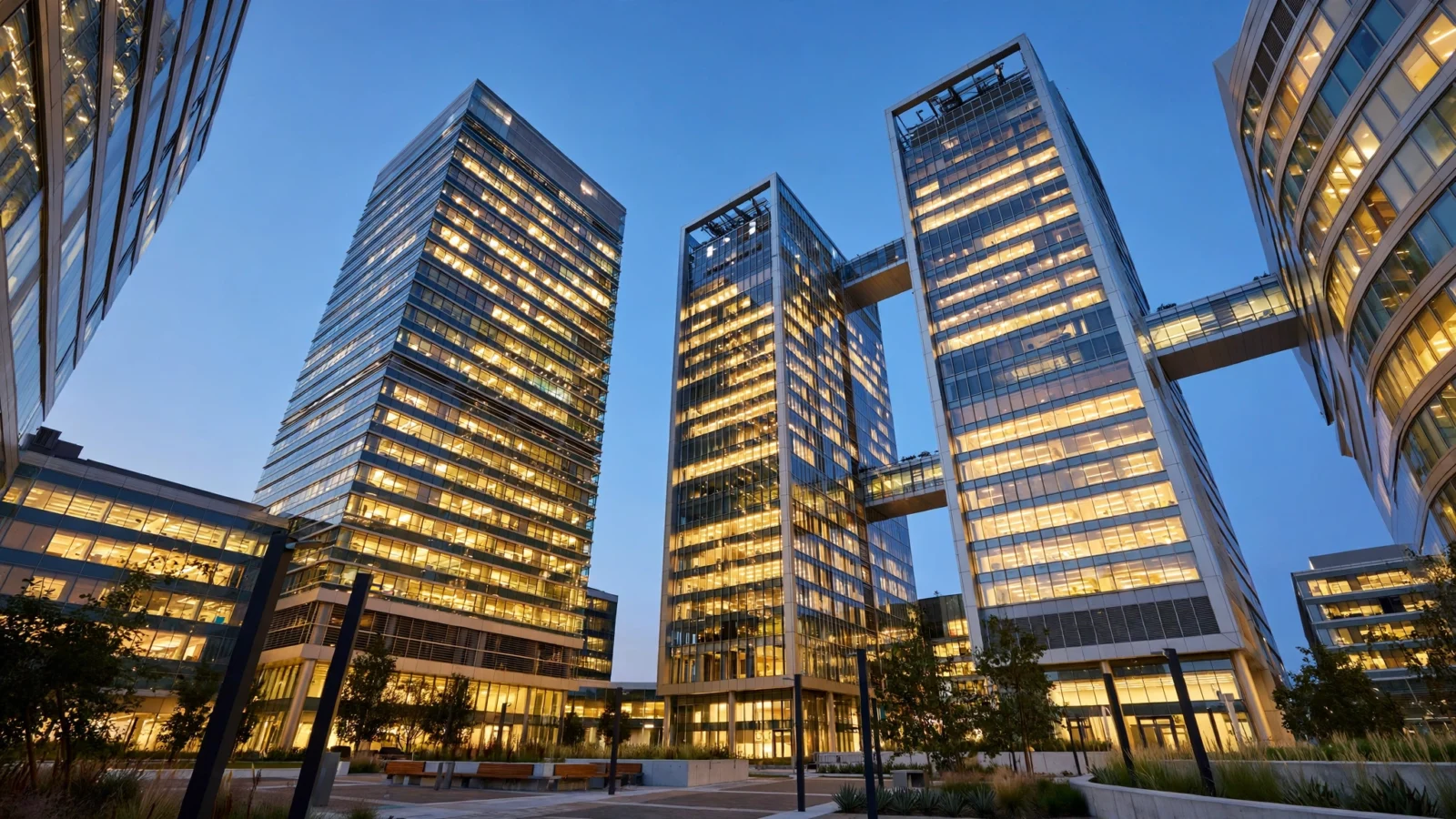 Glass office towers with lighted windows at dusk