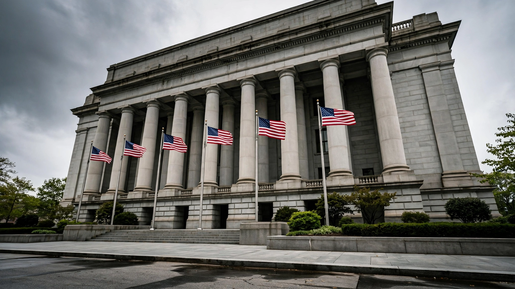 A federal courthouse with tall stone columns and American flags flying in front.