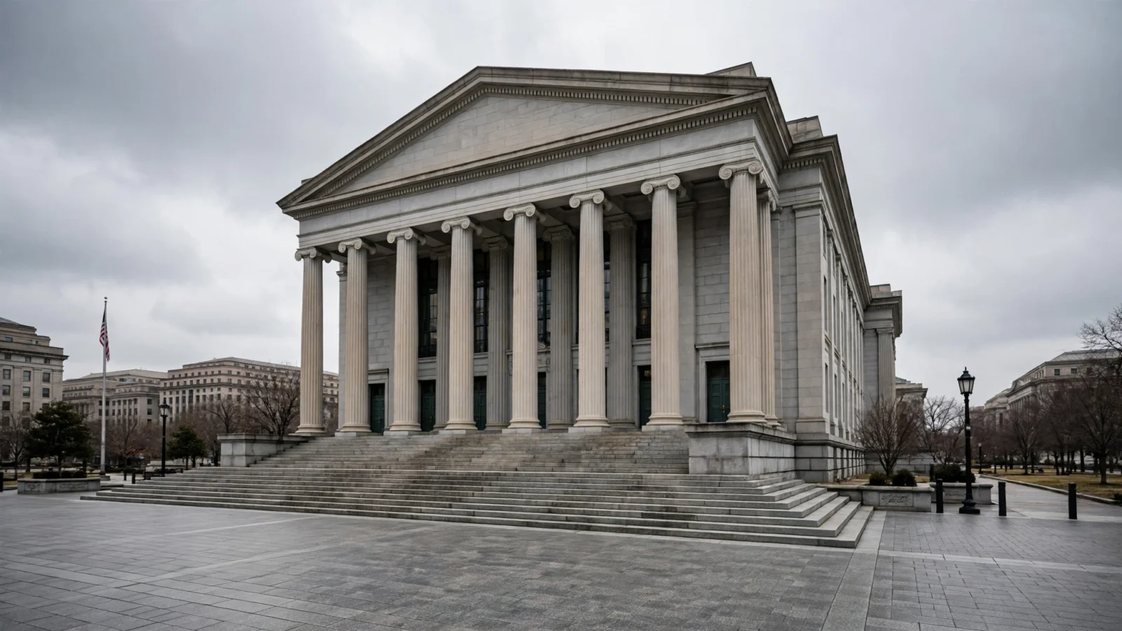 A neoclassical stone courthouse with tall columns and wide steps under an overcast sky