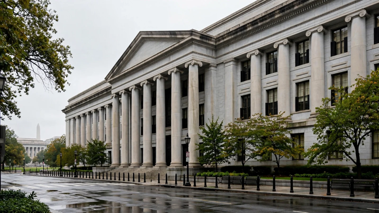 A large stone building with tall columns stands beside a wet street in Washington.