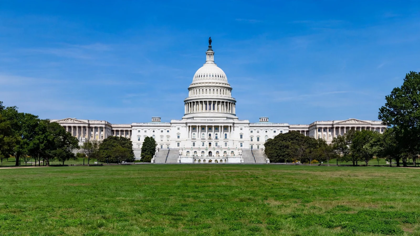 The United States Capitol building in Washington DC under a clear blue sky