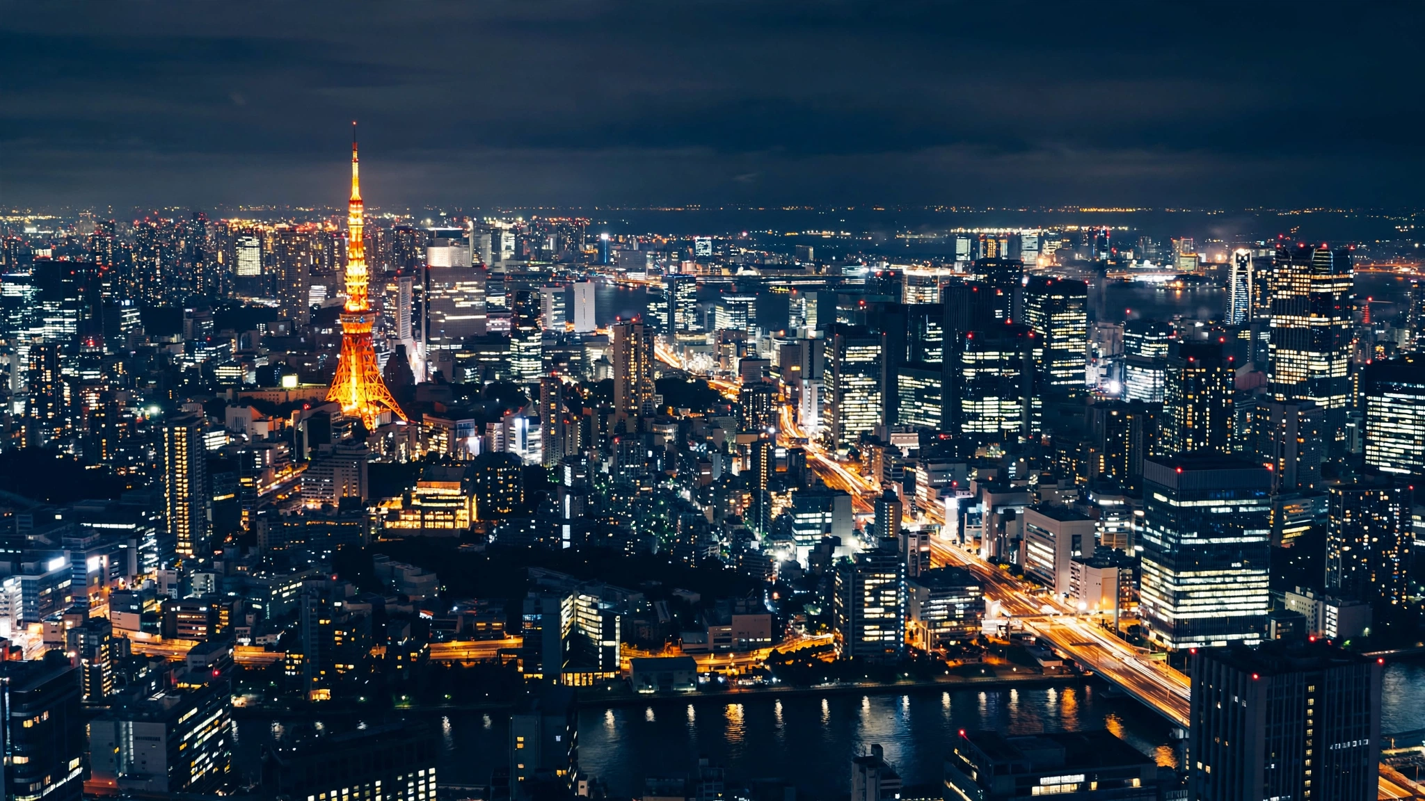 The Tokyo skyline at night with illuminated skyscrapers and Tokyo Tower