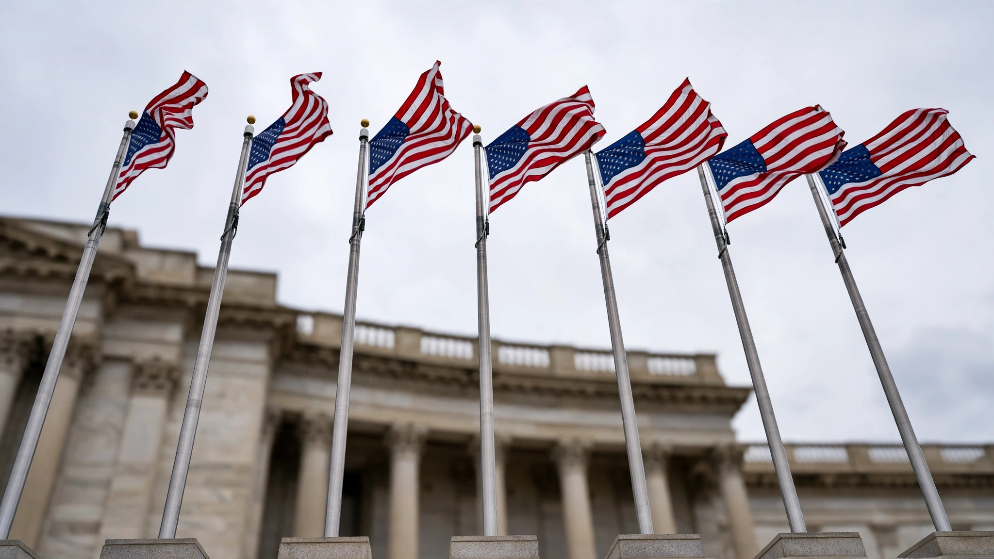 American flags on flagpoles in front of a government building