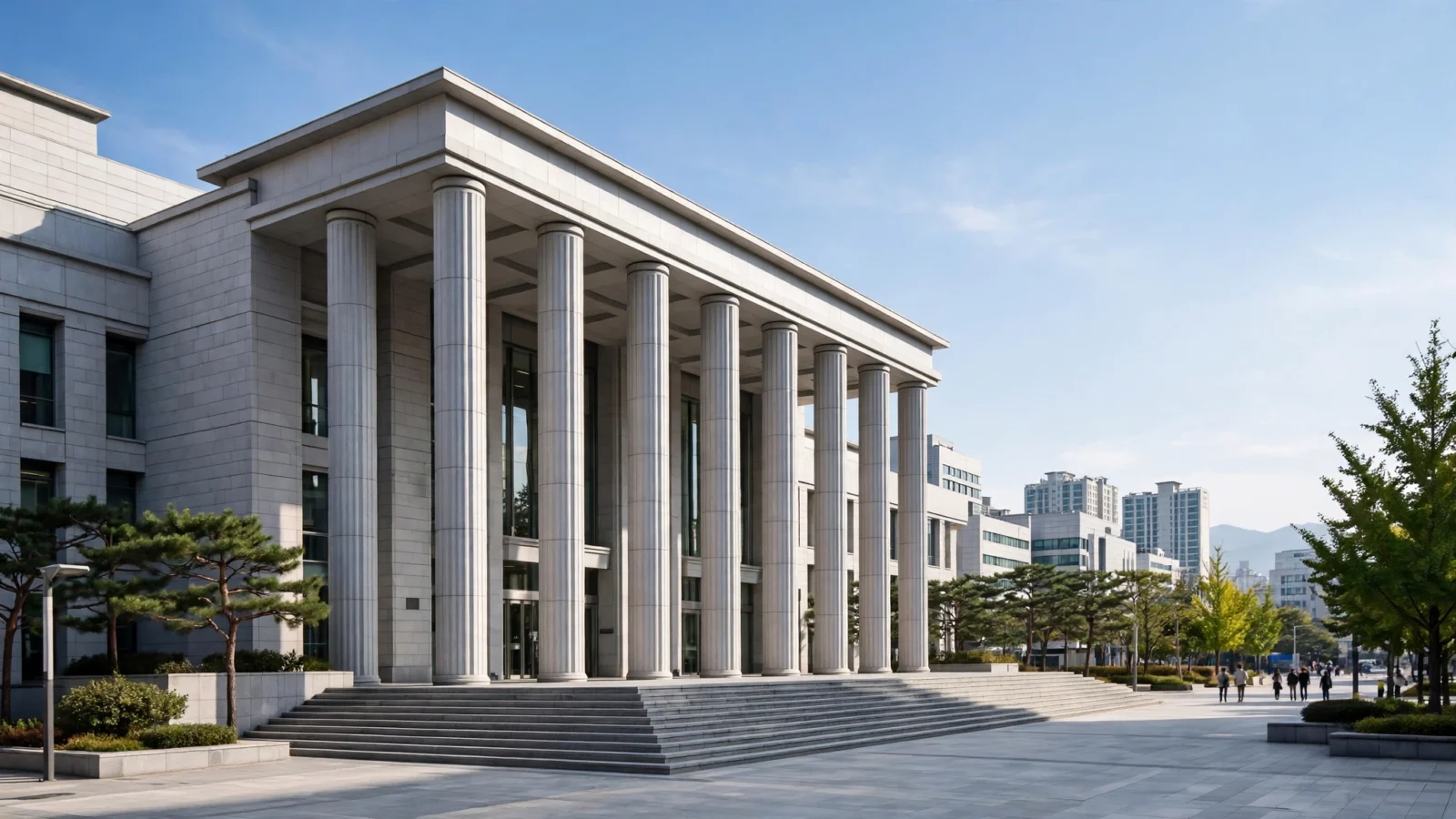 A modern courthouse building with tall stone columns and wide steps