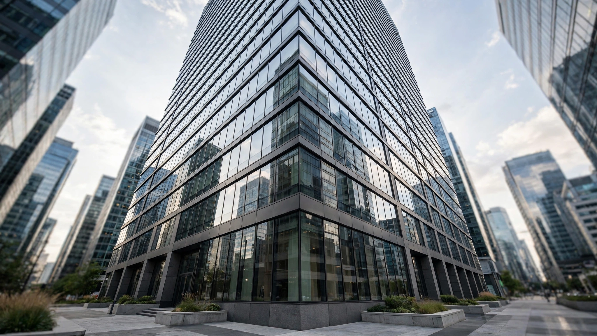 Modern glass office tower viewed from street level in a business district