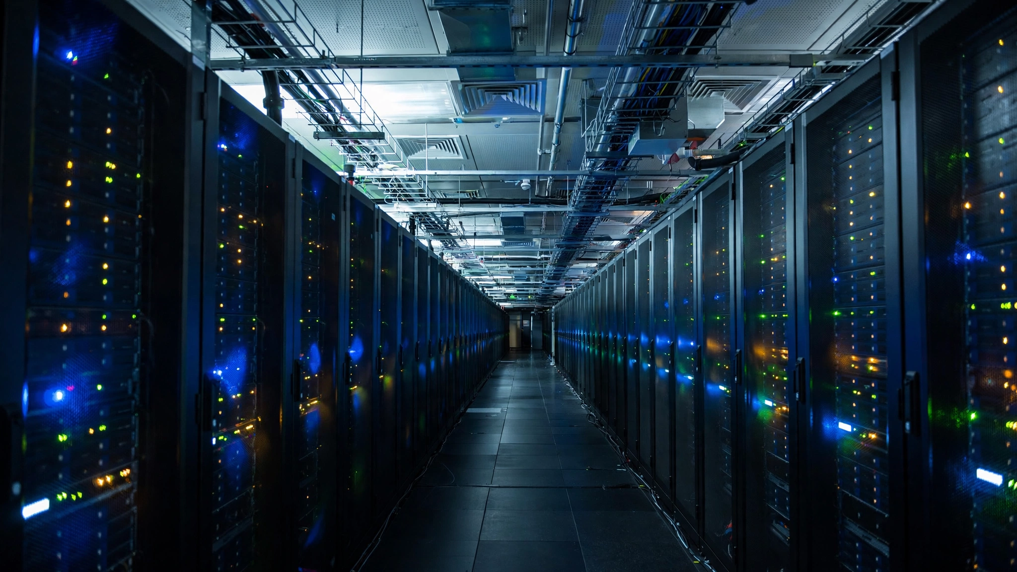 A corridor of server racks in a large data center