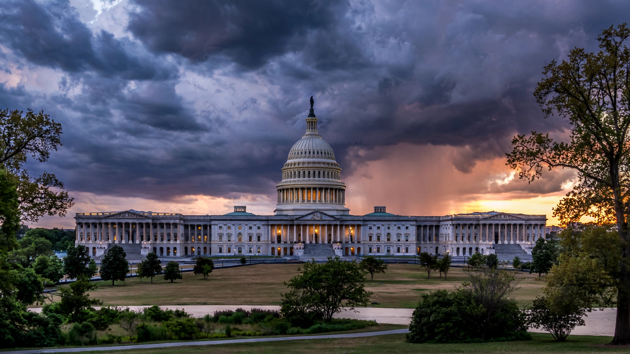 United States Capitol dome at dusk under dark clouds