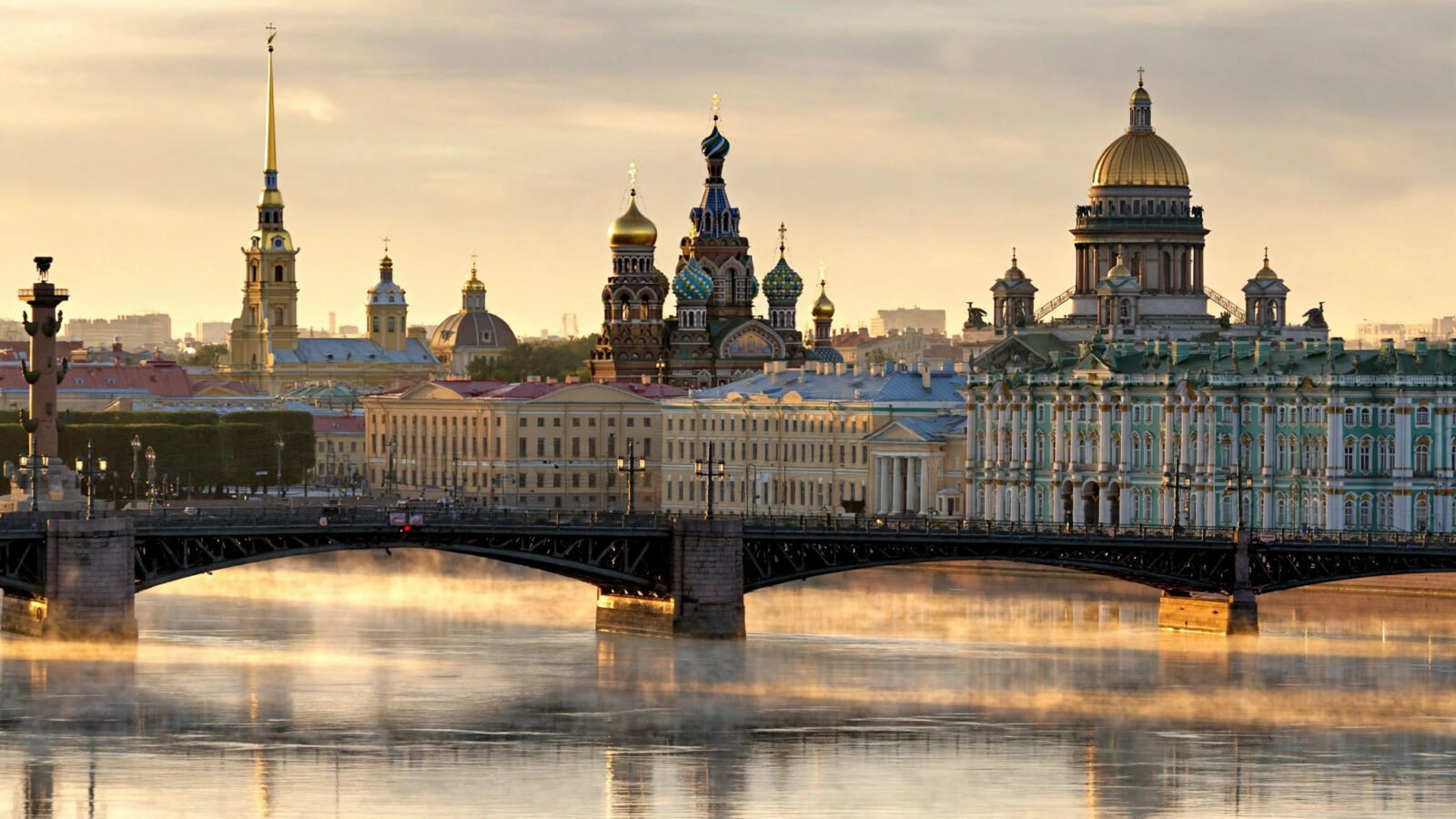 The St. Petersburg skyline at dawn, with church domes and historic palaces along the Neva River