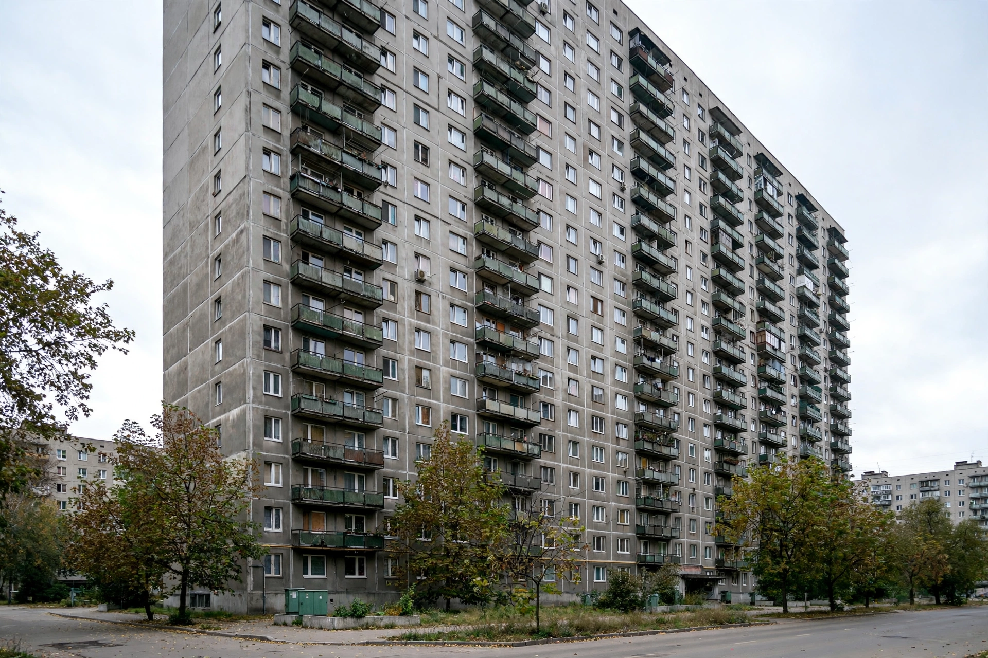 A tall Soviet-era apartment tower block in an Eastern European city in daylight