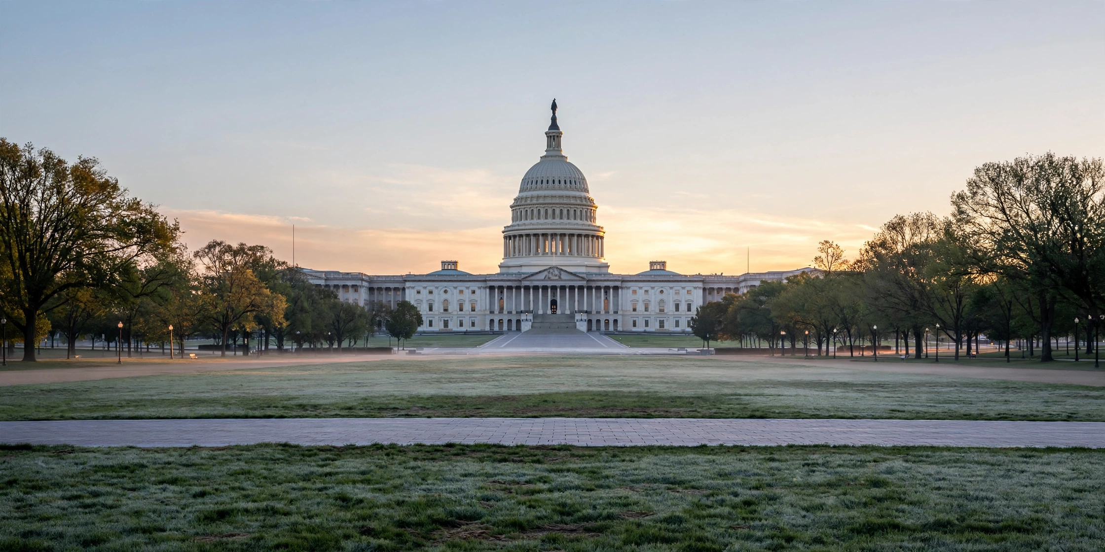 The United States Capitol building seen across the National Mall at dawn